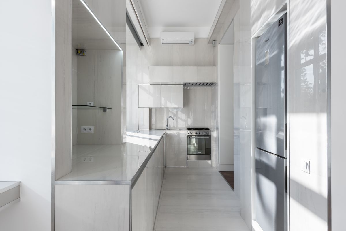 A bright white kitchen with a breakfast counter